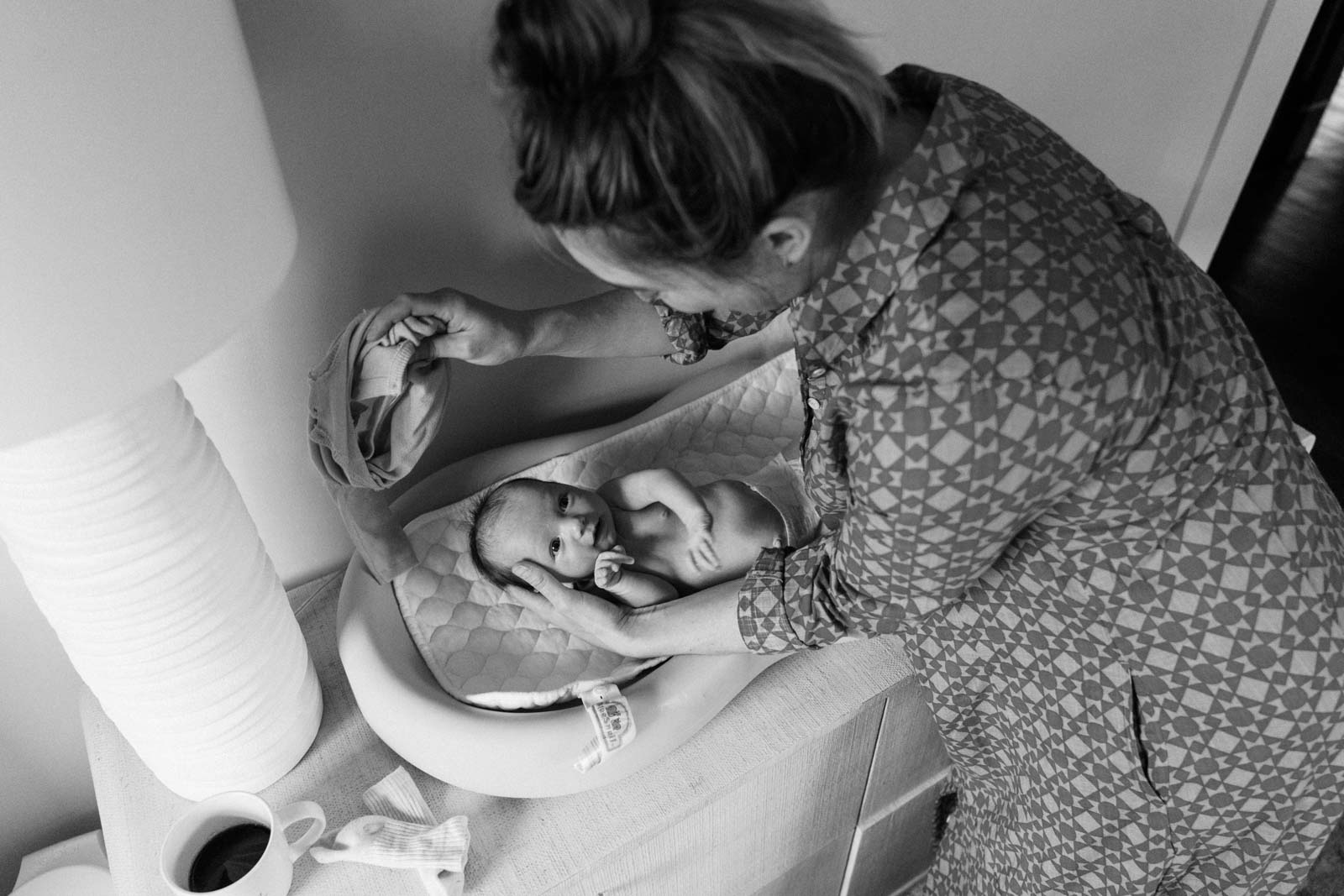 mother and newborn baby at changing table